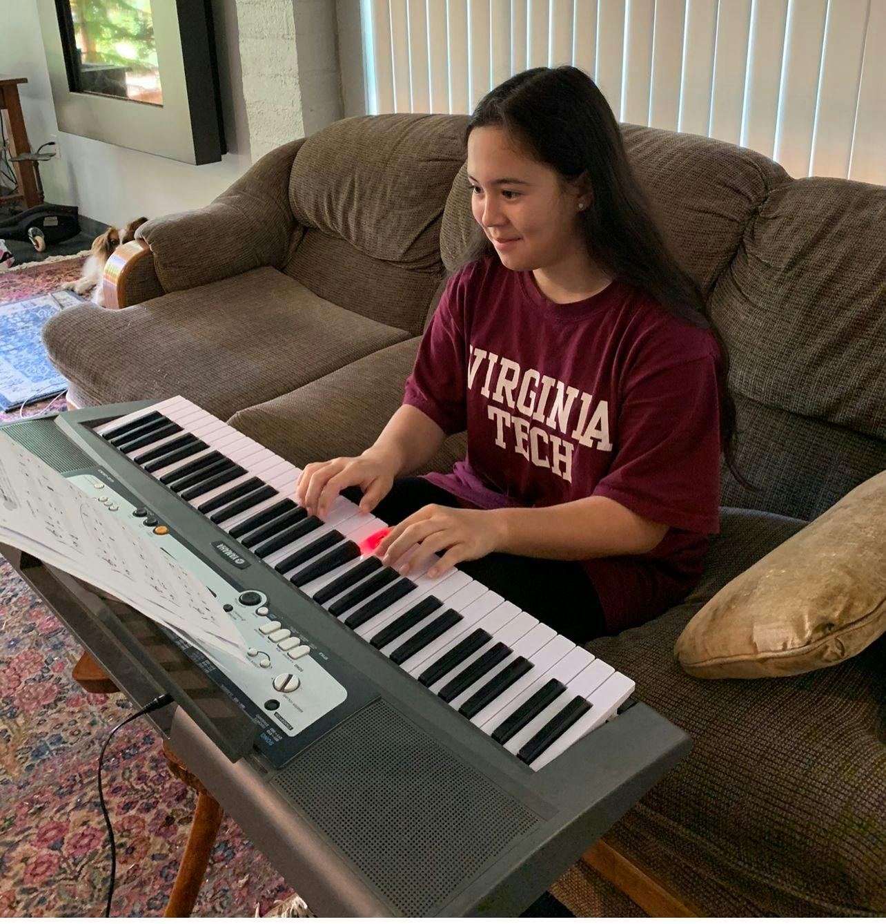A COS teen girl practices the piano