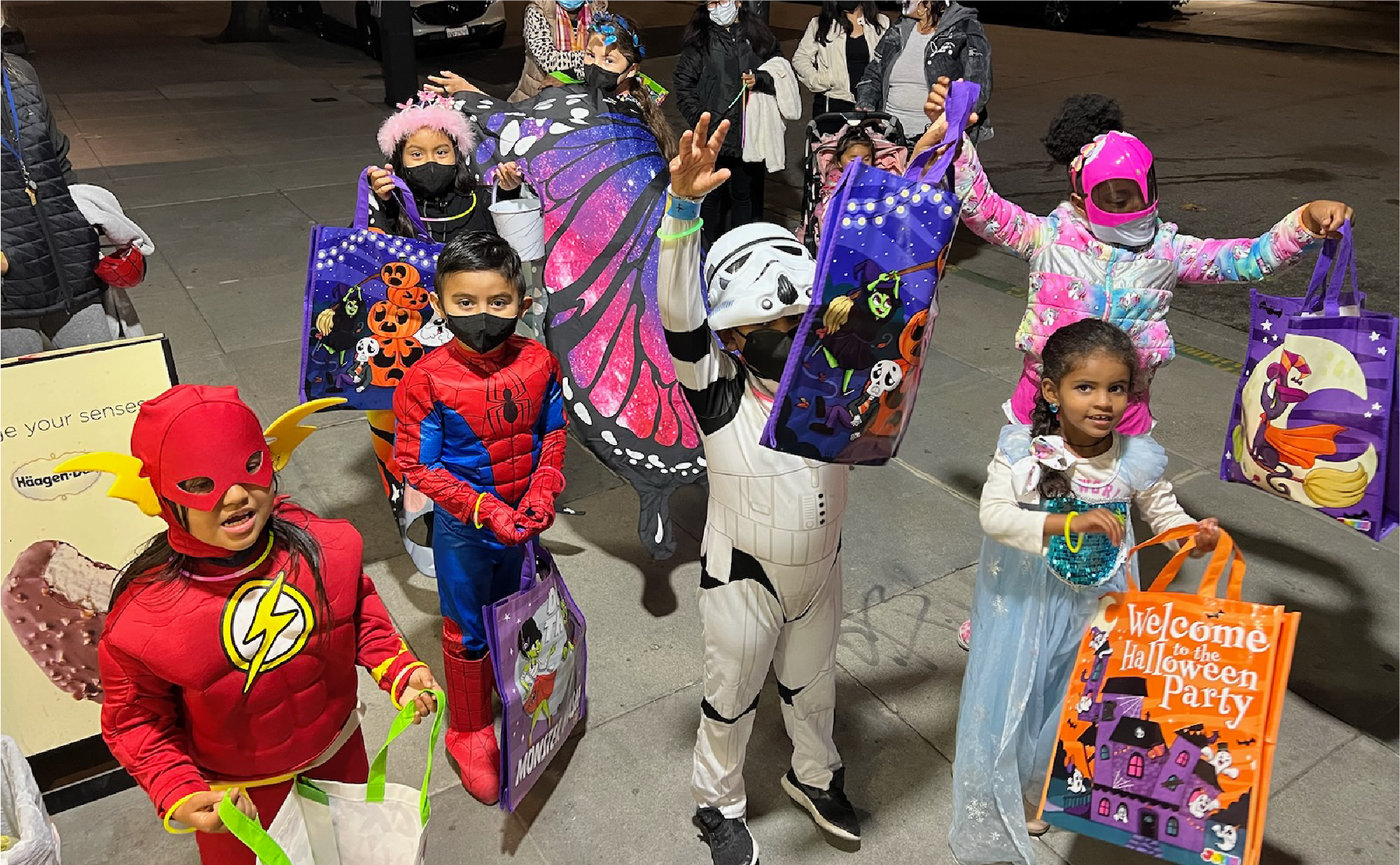 COS children trick-or-treating in Halloween costumes